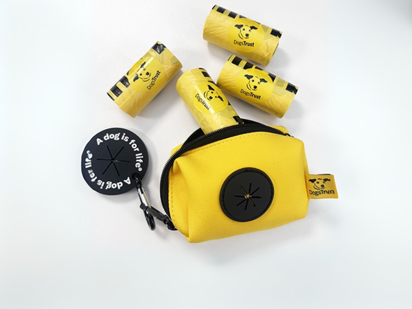 Black and yellow poo bag dispenser with clip and poop loop and yellow poo bags