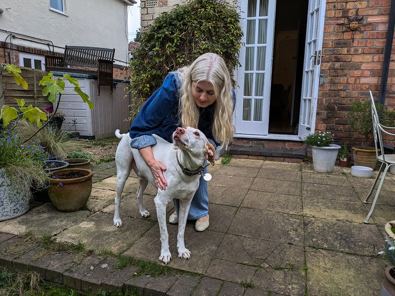Cody and his new owner Julia stand in the garden of his new forever home
