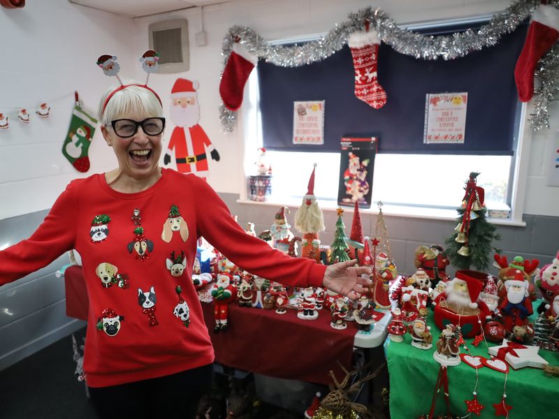 Staff member wearing festive jumper and smiling widely
